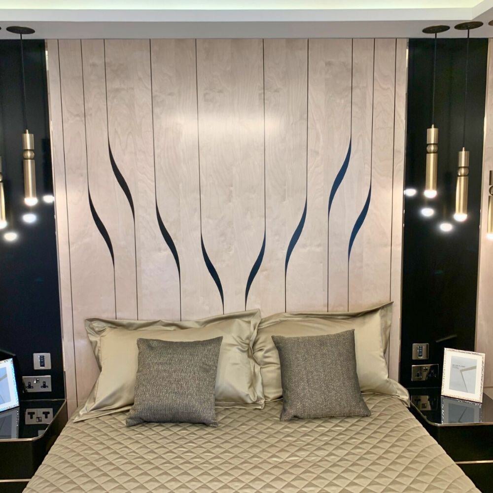 Elegant bedroom with custom headboard and pendant lighting.