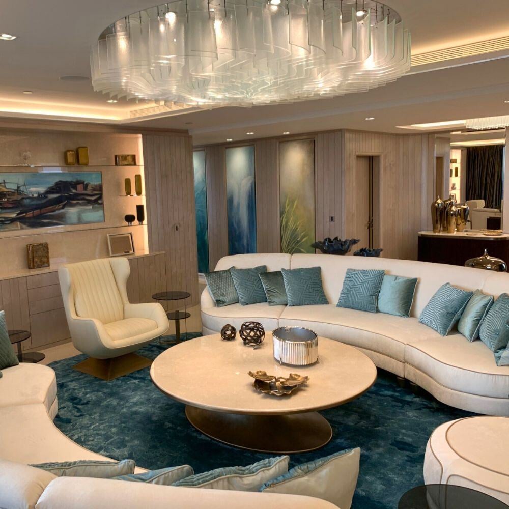 Modern lounge with curved seating and glass feature chandelier.