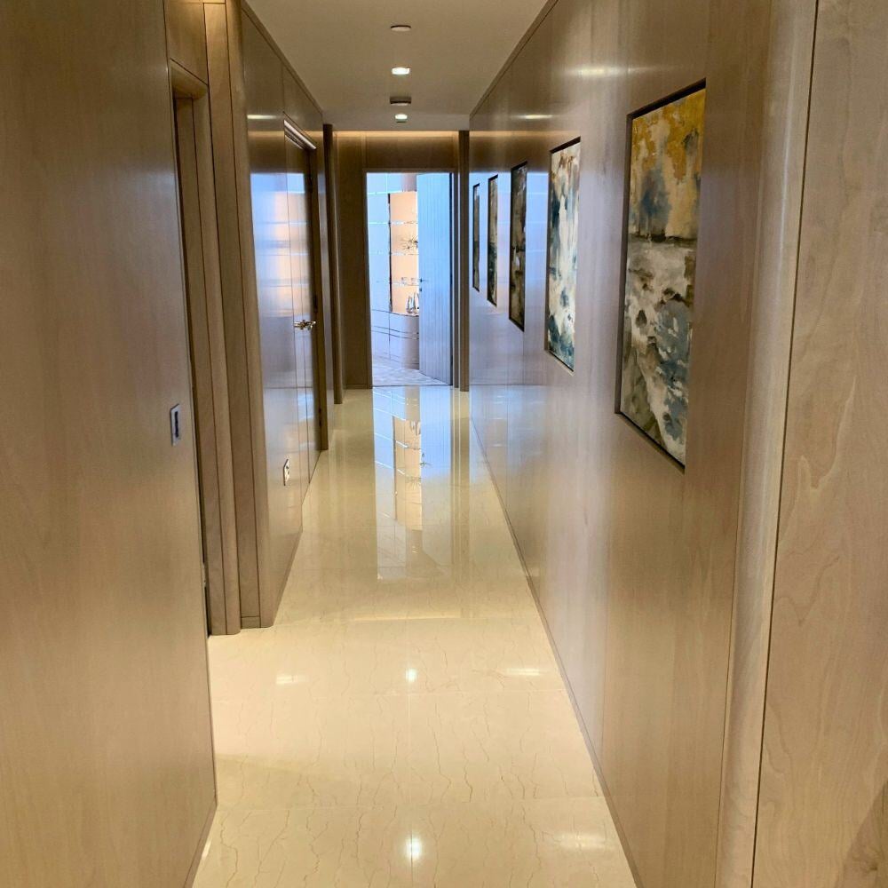 Polished hallway with contemporary art and wood cladding.