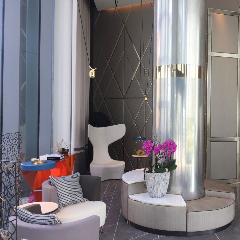 Corner area of Chelsea Waterfront with chrome column, curved seating and accent lighting.