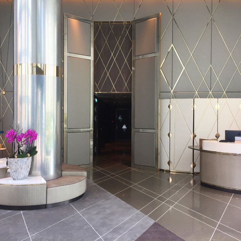 Mid-view entrance area in Chelsea Waterfront with column, reception and grand wall panels.