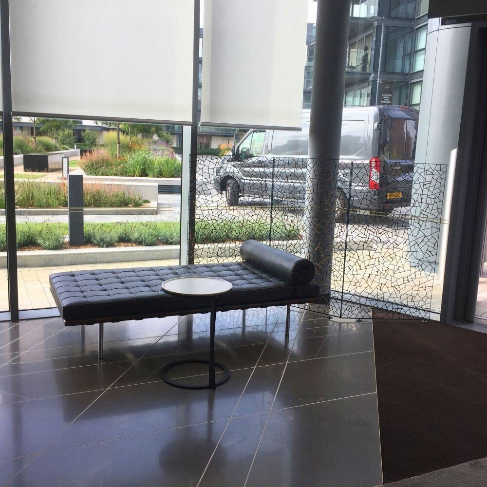 Relaxation corner inside Chelsea Waterfront with designer daybed and mosaic privacy panel.