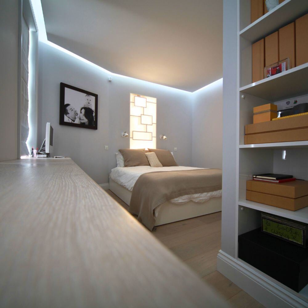 Bedroom space with desk area, neutral tones, and generous natural light.