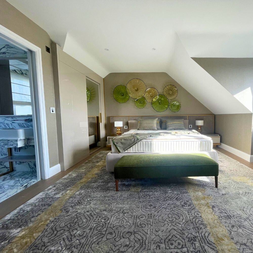 Master bedroom with soft colour palette, custom wall panels, and view into luxury marble ensuite.