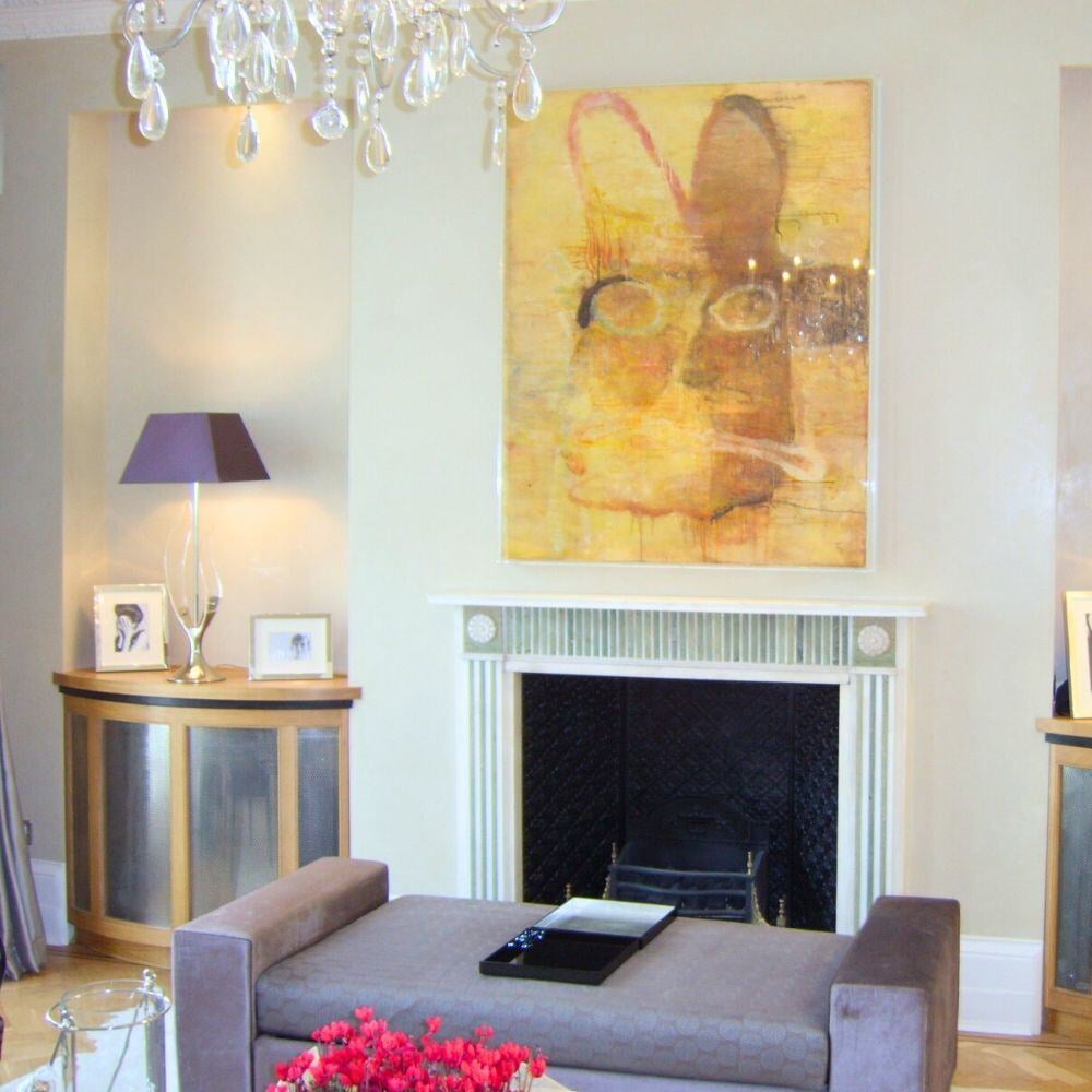 Classic-meets-modern fireplace with bold artwork and elegant chandelier detailing.