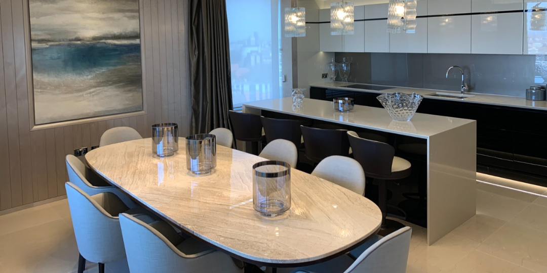 Elegant bespoke kitchen remodel with open-plan layout, custom cabinetry, marble dining table and integrated lighting design